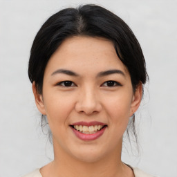 Joyful asian young-adult female with medium  black hair and brown eyes