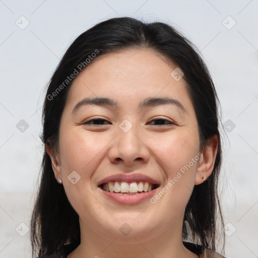 Joyful asian young-adult female with long  brown hair and brown eyes