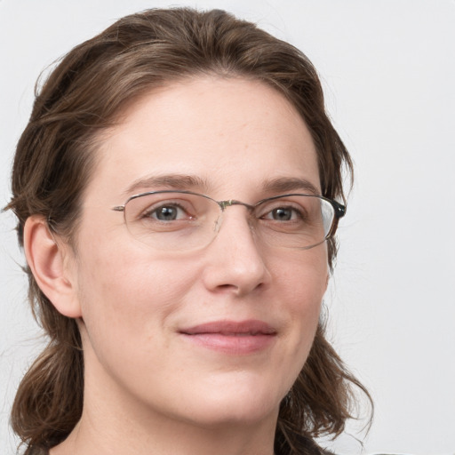 Joyful white adult female with long  brown hair and grey eyes