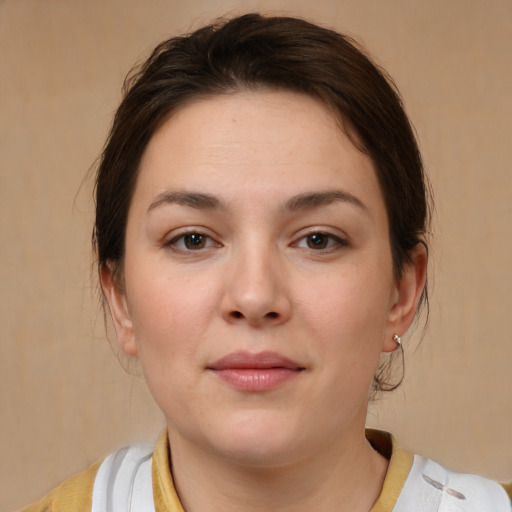 Joyful white young-adult female with medium  brown hair and brown eyes