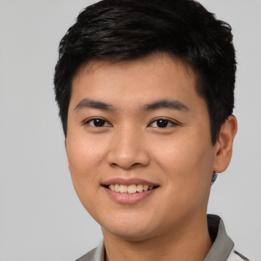 Joyful asian young-adult male with short  black hair and brown eyes