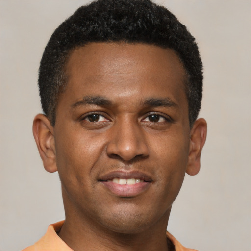 Joyful latino young-adult male with short  brown hair and brown eyes