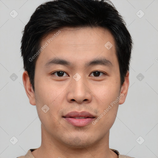 Joyful asian young-adult male with short  brown hair and brown eyes