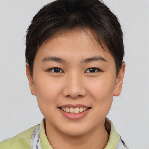 Joyful asian young-adult female with short  brown hair and brown eyes
