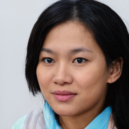 Joyful asian young-adult female with medium  black hair and brown eyes