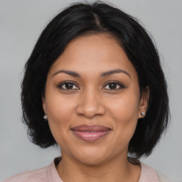 Joyful black adult female with medium  brown hair and brown eyes