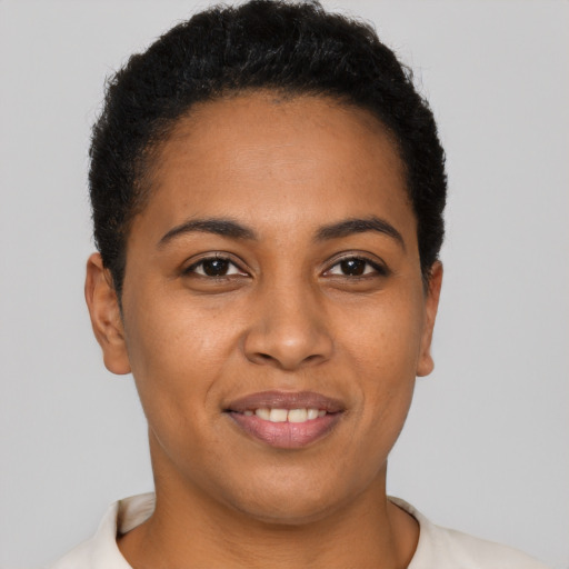 Joyful black young-adult female with short  brown hair and brown eyes