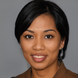 Joyful latino young-adult female with medium  black hair and brown eyes