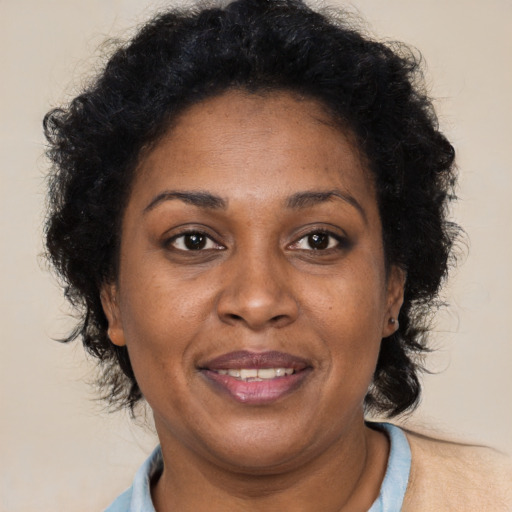 Joyful black adult female with short  brown hair and brown eyes