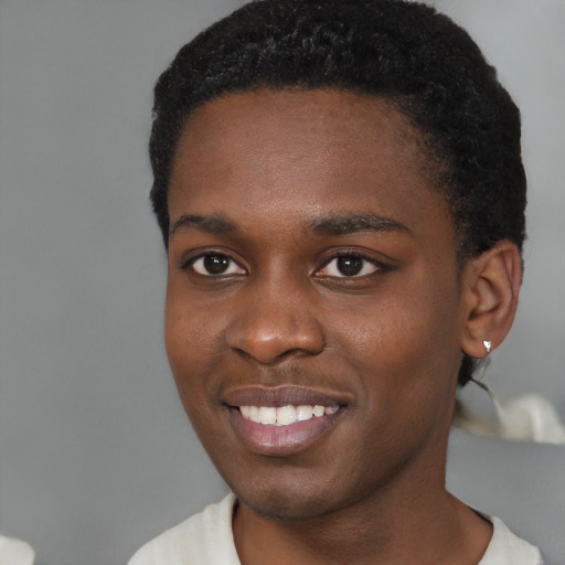 Joyful black young-adult male with short  black hair and brown eyes