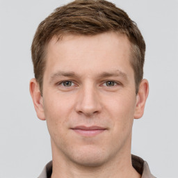 Joyful white young-adult male with short  brown hair and grey eyes