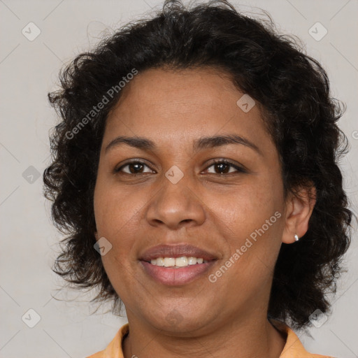 Joyful black adult female with medium  brown hair and brown eyes