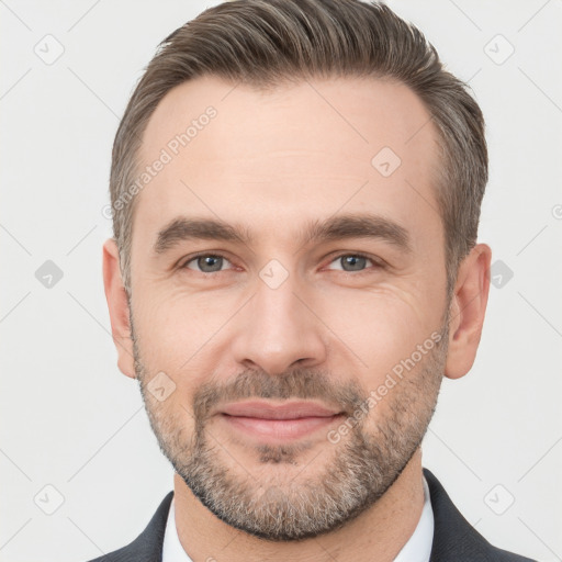 Joyful white adult male with short  brown hair and brown eyes