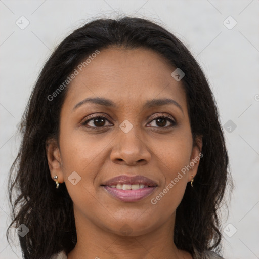 Joyful black young-adult female with long  brown hair and brown eyes