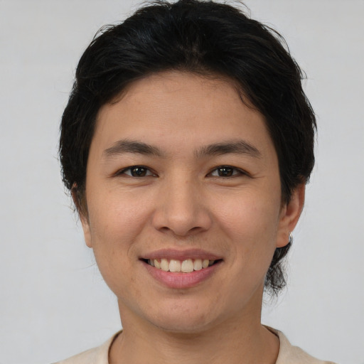 Joyful asian young-adult female with short  brown hair and brown eyes
