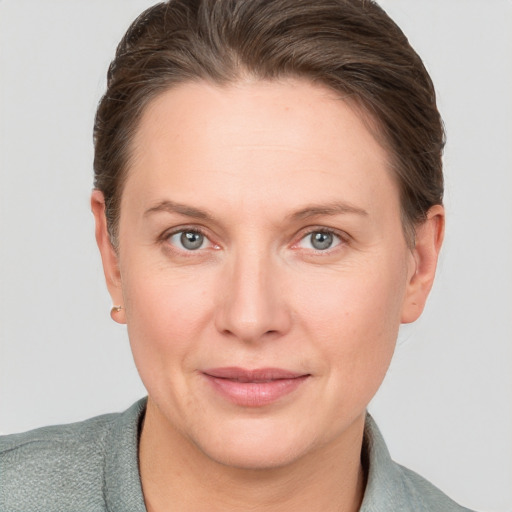 Joyful white adult female with short  brown hair and grey eyes