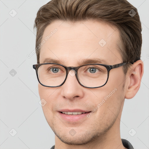 Joyful white adult male with short  brown hair and grey eyes