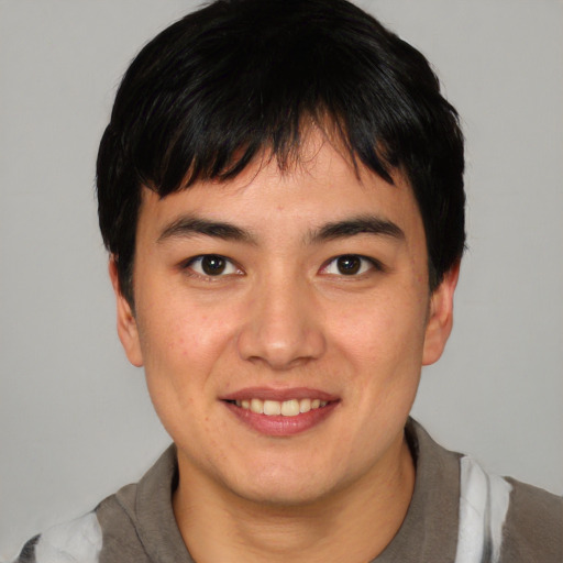 Joyful asian young-adult male with short  black hair and brown eyes