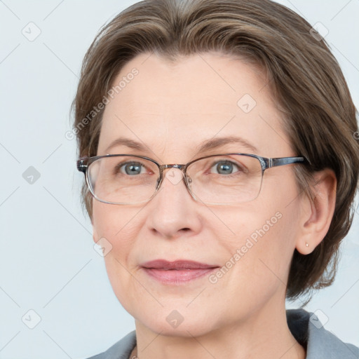 Joyful white adult female with medium  brown hair and grey eyes