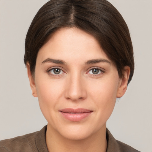 Joyful white young-adult female with short  brown hair and brown eyes