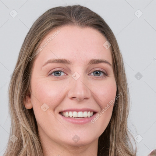 Joyful white young-adult female with long  brown hair and blue eyes