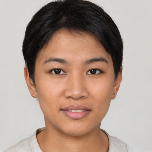 Joyful asian young-adult female with short  brown hair and brown eyes