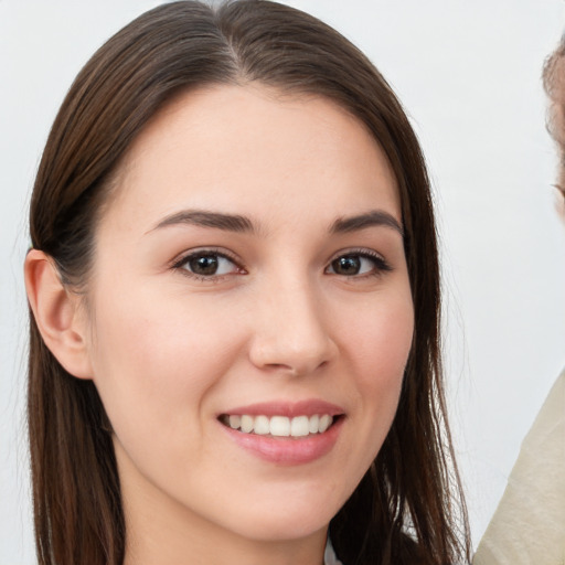 Joyful white young-adult female with long  brown hair and brown eyes