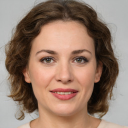 Joyful white young-adult female with medium  brown hair and green eyes