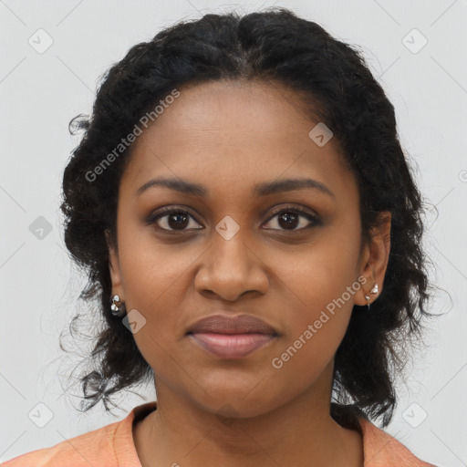 Joyful black young-adult female with long  brown hair and brown eyes