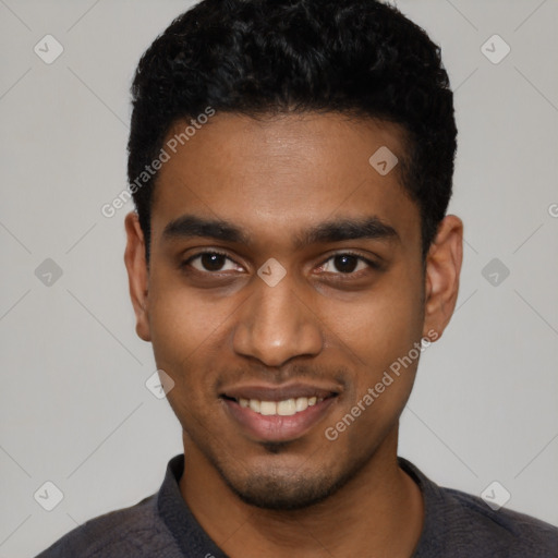 Joyful black young-adult male with short  black hair and brown eyes