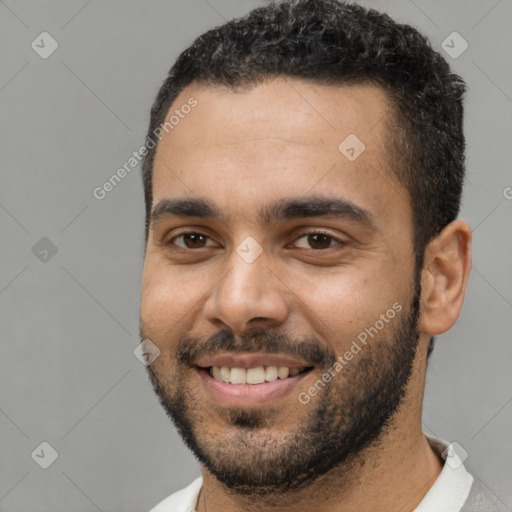 Joyful black young-adult male with short  black hair and brown eyes