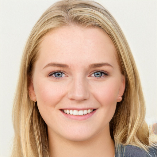 Joyful white young-adult female with long  brown hair and blue eyes