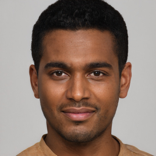 Joyful black young-adult male with short  black hair and brown eyes