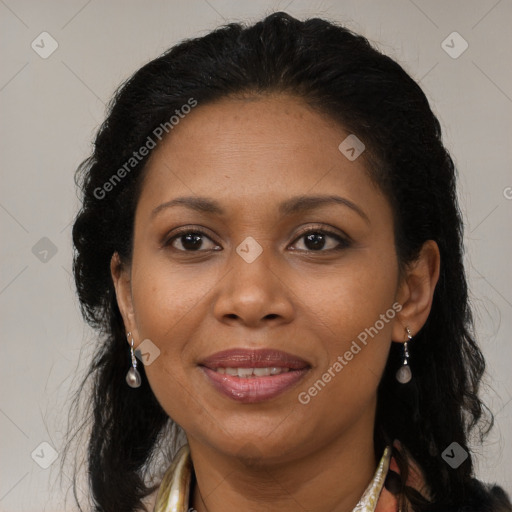 Joyful black adult female with long  brown hair and brown eyes