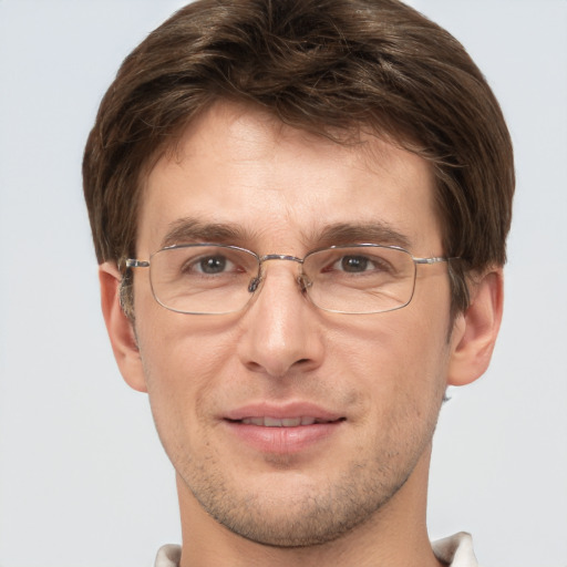 Joyful white adult male with short  brown hair and grey eyes