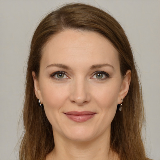 Joyful white young-adult female with medium  brown hair and green eyes