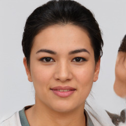 Joyful latino young-adult female with medium  brown hair and brown eyes