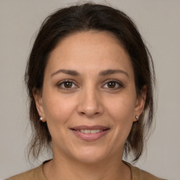 Joyful white adult female with medium  brown hair and brown eyes