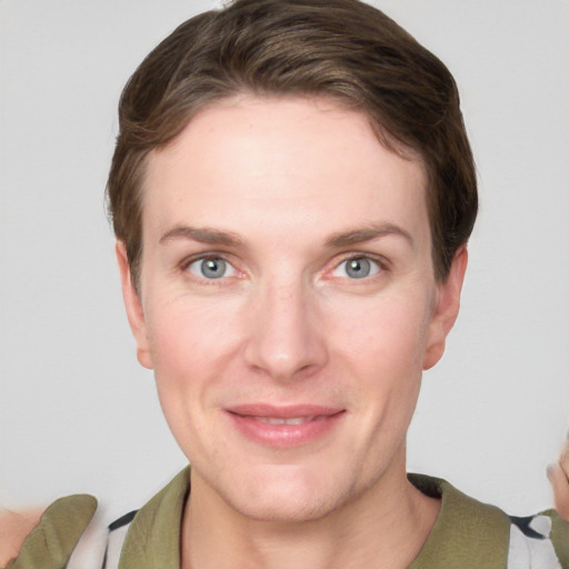 Joyful white young-adult female with short  brown hair and grey eyes