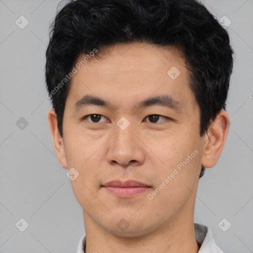 Joyful asian young-adult male with short  black hair and brown eyes