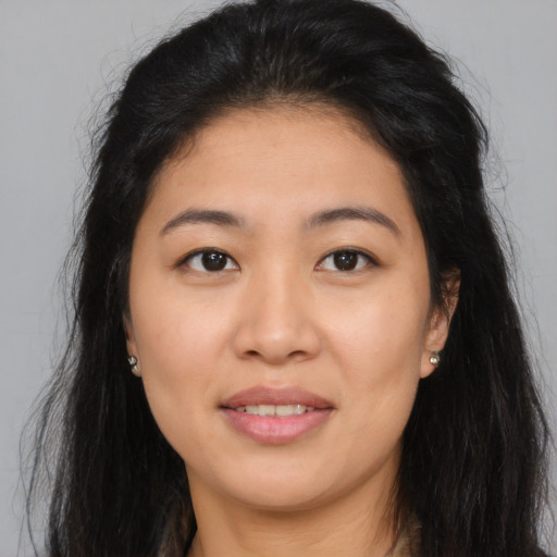 Joyful asian young-adult female with long  brown hair and brown eyes