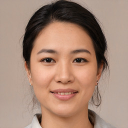 Joyful asian young-adult female with medium  brown hair and brown eyes