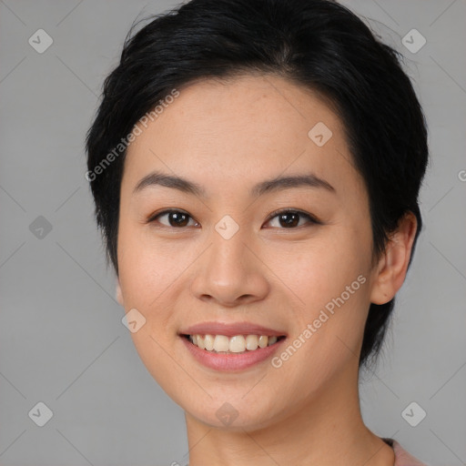 Joyful asian young-adult female with medium  black hair and brown eyes