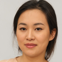 Joyful asian young-adult female with medium  brown hair and brown eyes