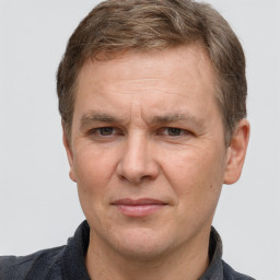 Joyful white adult male with short  brown hair and grey eyes