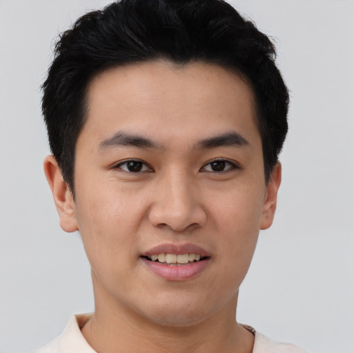 Joyful asian young-adult male with short  black hair and brown eyes