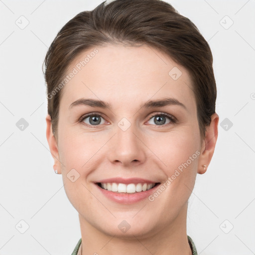 Joyful white young-adult female with short  brown hair and grey eyes