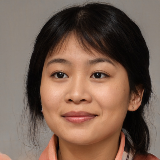 Joyful asian young-adult female with medium  brown hair and brown eyes
