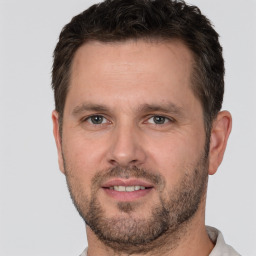 Joyful white adult male with short  brown hair and brown eyes