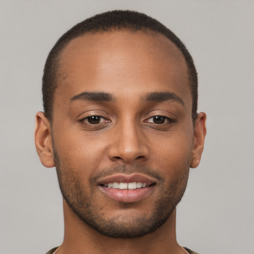 Joyful black young-adult male with short  brown hair and brown eyes